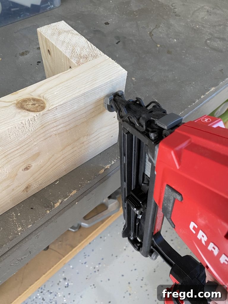 Two side pieces securely attached to the front 2x6 board using brad nails and wood glue, forming the initial 'U' shape.