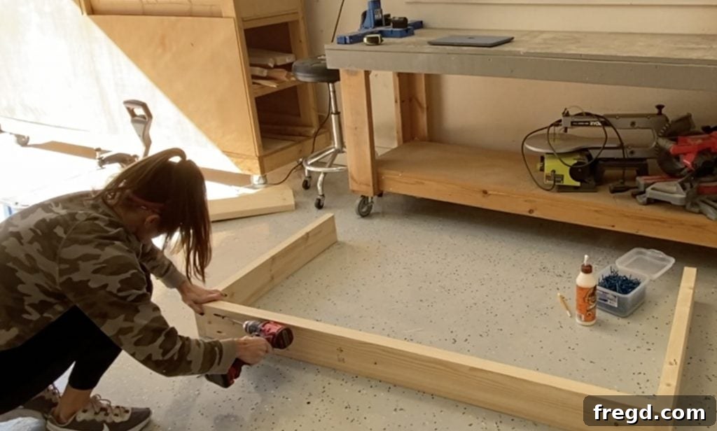 Farmhouse Fresh: Build Your Own Console 3 Attaching legs to the long runner of the console table base with pocket hole screws and wood glue.