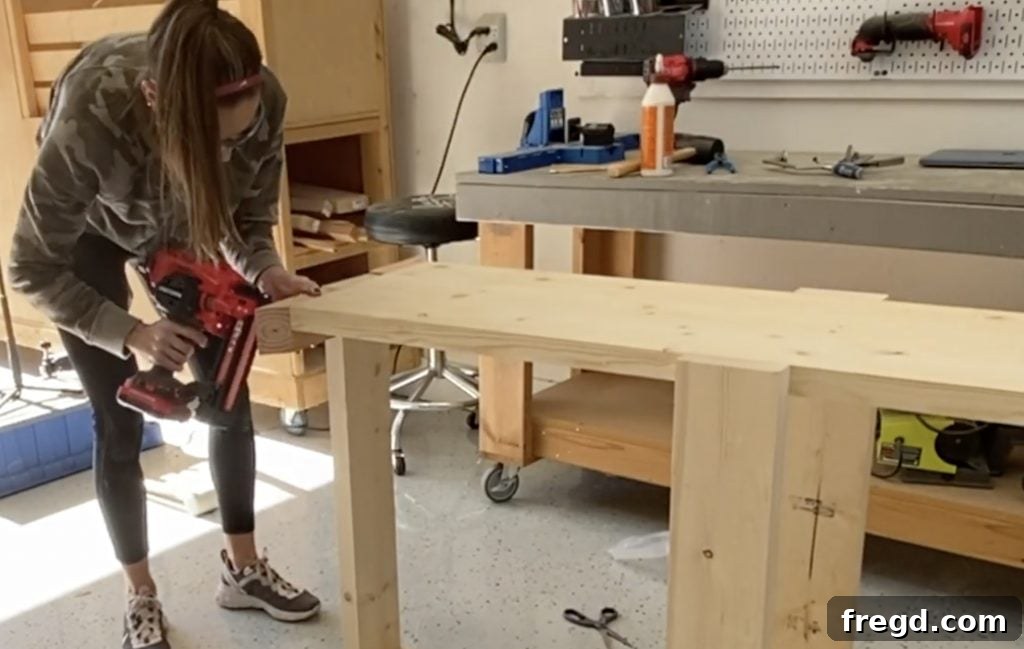 Farmhouse Fresh: Build Your Own Console 8 Installing short trim pieces on the console table, flush with the top and legs.