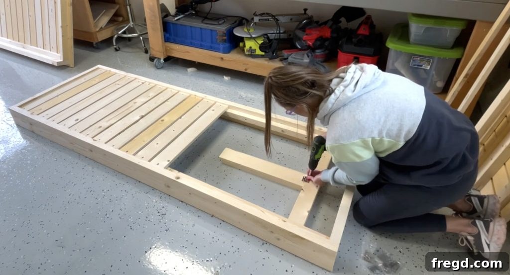 Attaching the arm assembly to the cross support with a hinge