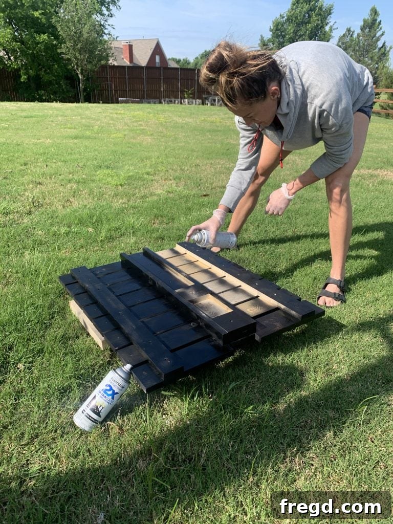Applying indoor/outdoor spray paint to the chair