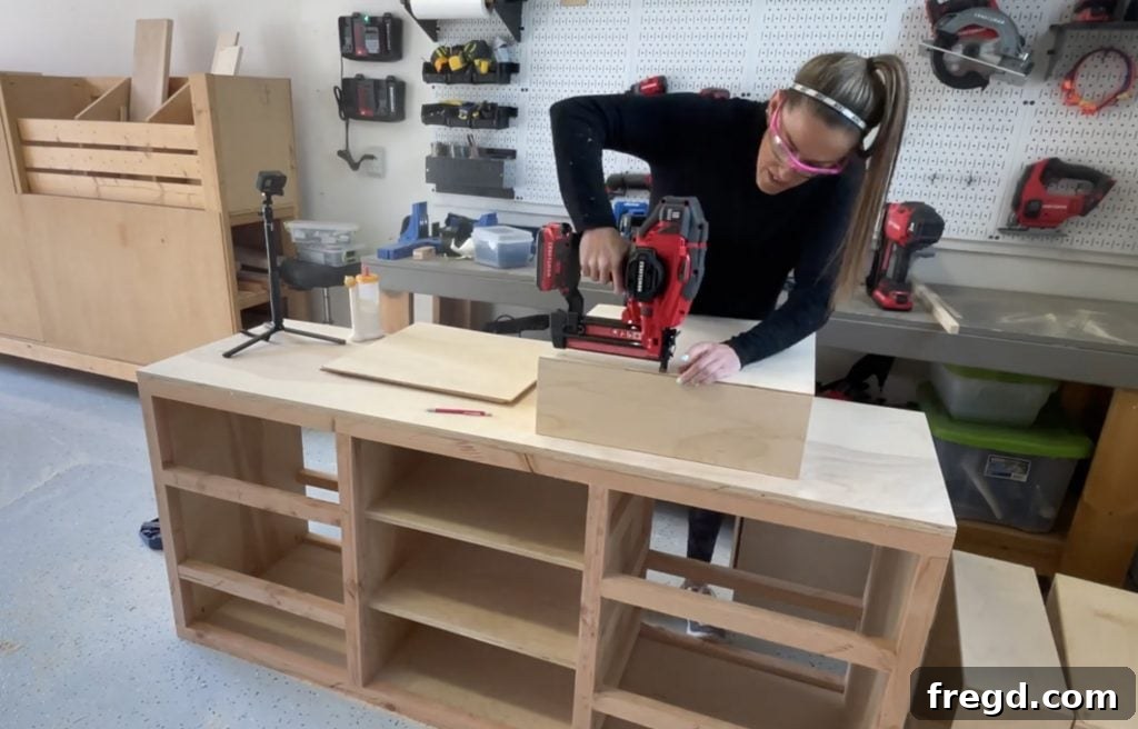 Attaching drawer bottoms to the assembled drawer boxes.