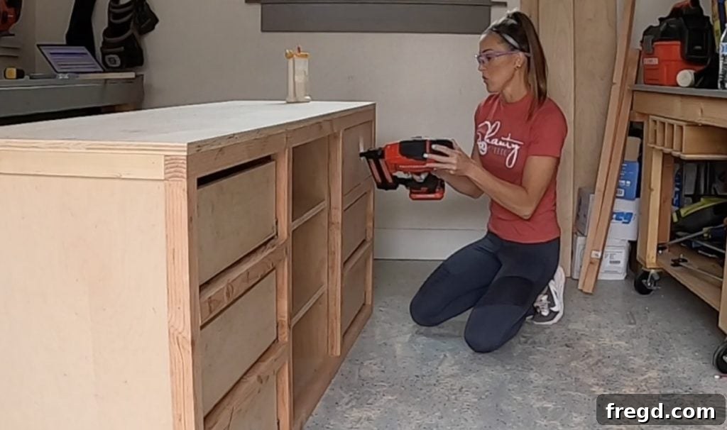 Attaching drawer faces to the front of the drawer boxes with a consistent gap.