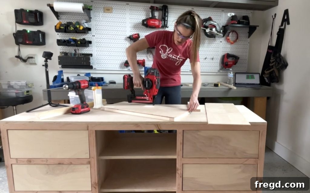 Attaching plywood panels to the back of the door frames with staples and wood glue.