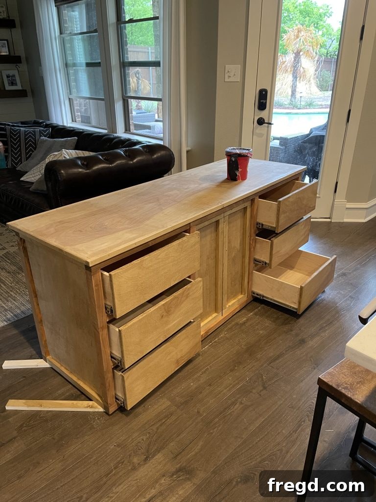 Sanding the dresser to a smooth finish and preparing for paint or stain.