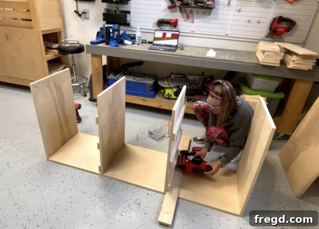 Securing bottom cleats to the middle dividers with brad nails and wood glue.