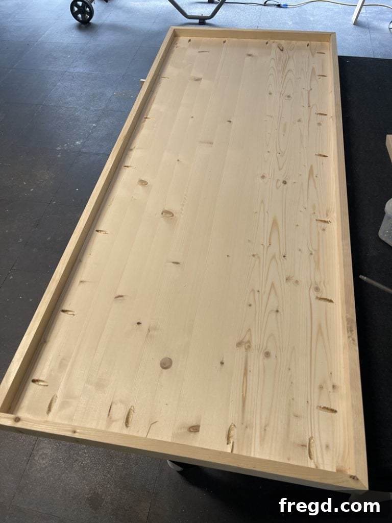 The tabletop with all trim boards attached, showing a robust and finished edge.