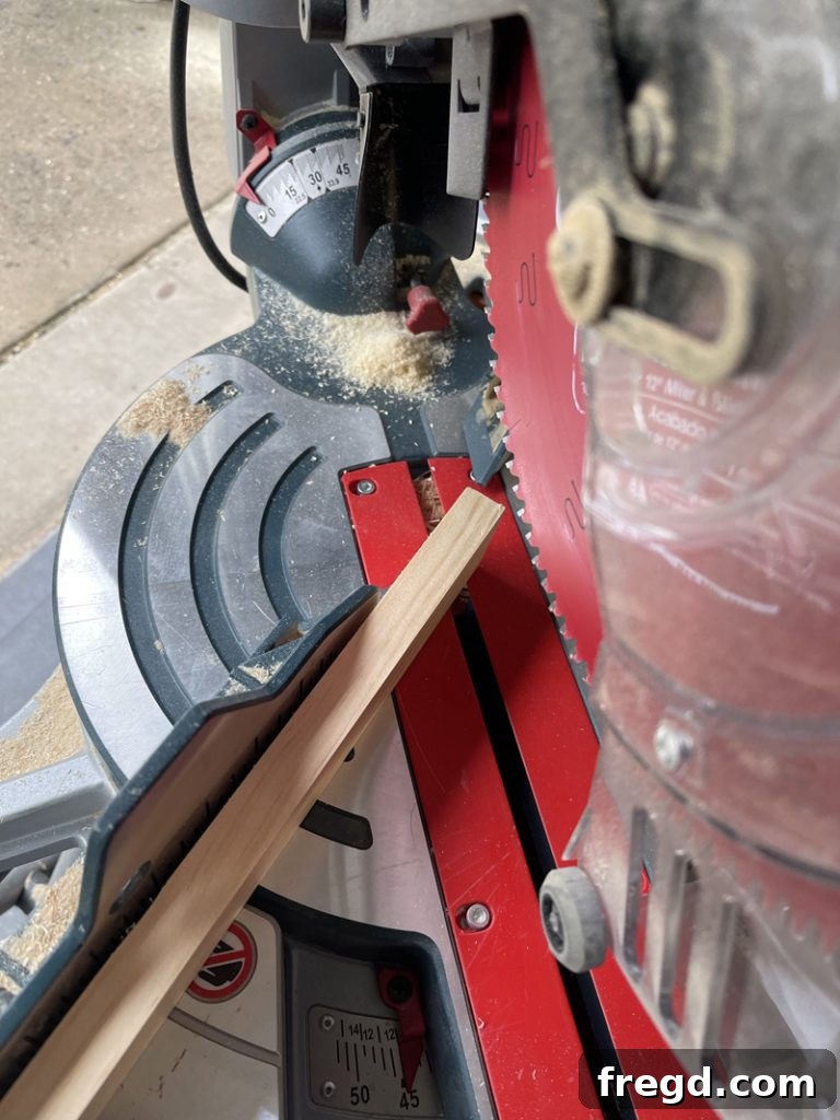 A wood trim piece being carefully positioned along the edge of a tabletop before attachment.