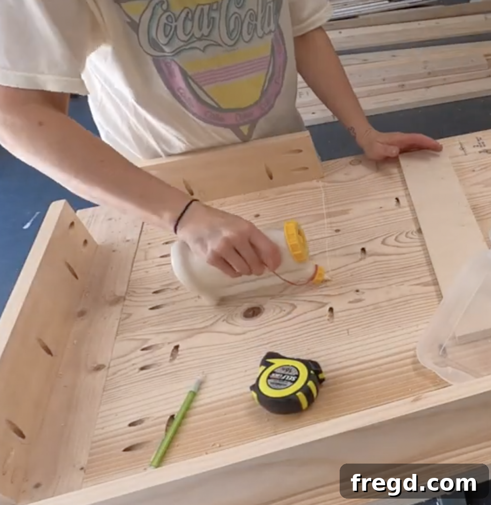 Build Your Own Modern Farmhouse Desk 13 Apply wood glue to the desktop for attaching drawer support boards