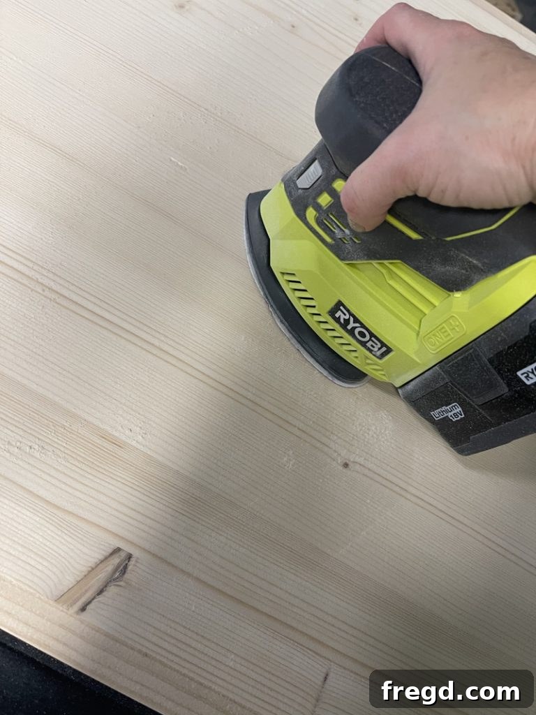 Craft a Charming Dollhouse Book Nook 16 Sanding the entire dollhouse bookcase to achieve a smooth finish
