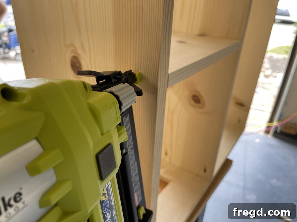 Craft a Charming Dollhouse Book Nook 6 Attaching the dollhouse bookcase dividers to the shelves with a nail gun, brad nails, and wood glue