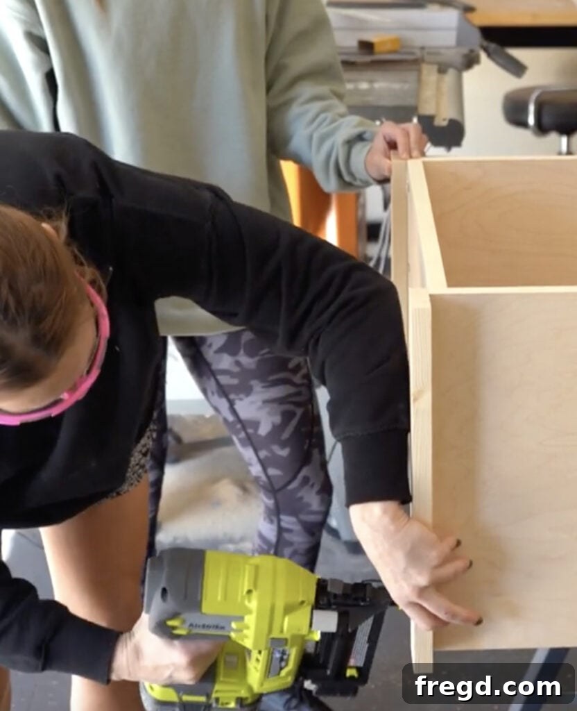 Design Your Own Home Office Workstation 13 Attaching 1x3 trim to the side of the bookcase