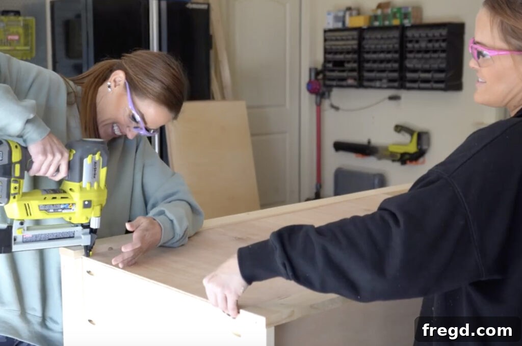 Design Your Own Home Office Workstation 22 Attaching the 1/4 inch plywood back to the bookcase with staples