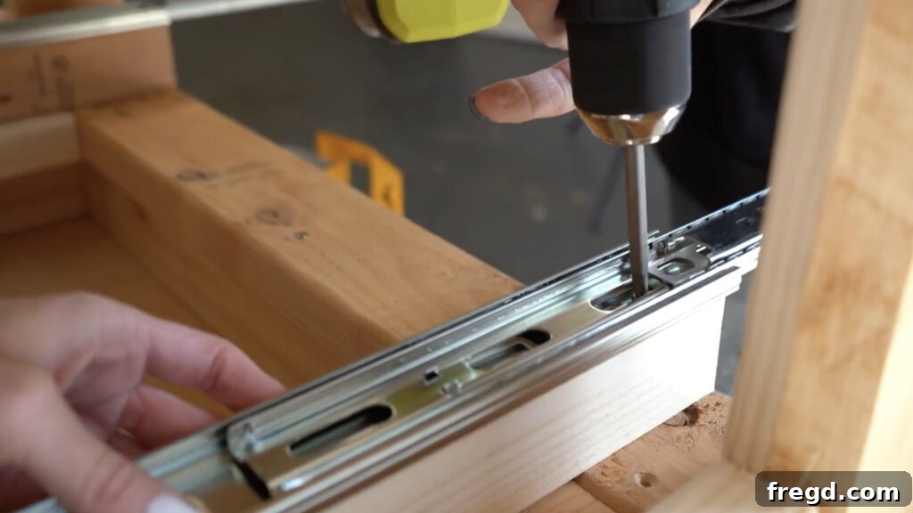 Modern DIY Nightstand with Hidden Storage Drawer 11 Attaching the drawer slides to the newly installed cleats within the nightstand structure