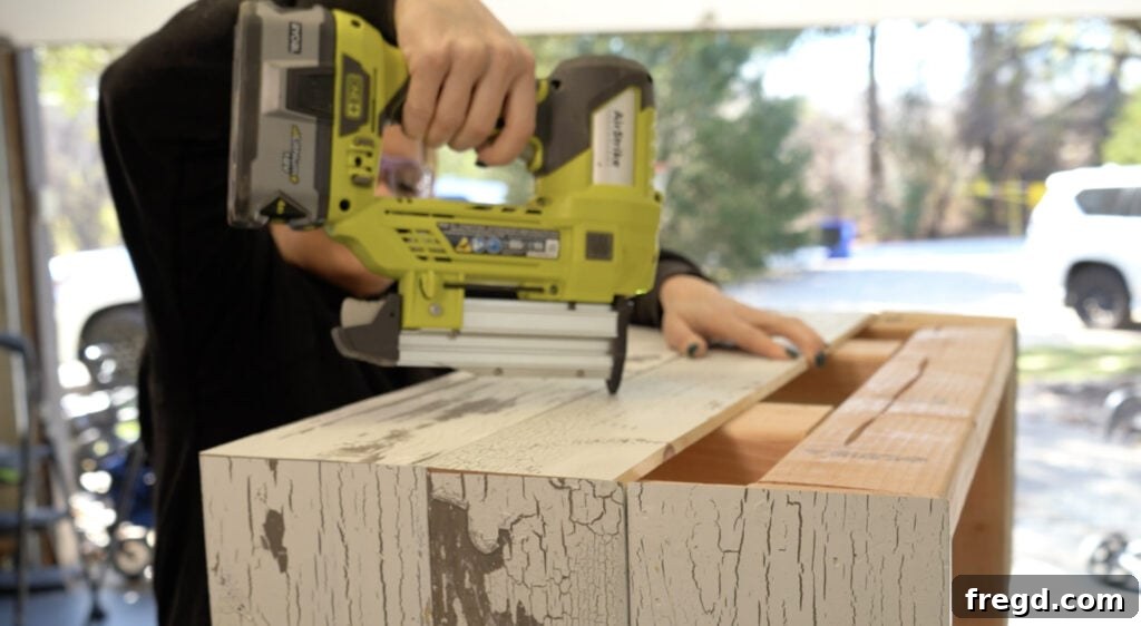 Modern DIY Nightstand with Hidden Storage Drawer 18 Adding the barnwood trim boards to the top surface of the nightstand for a finished look