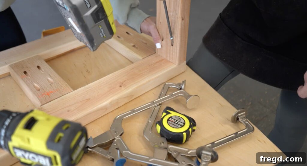 Modern DIY Nightstand with Hidden Storage Drawer 6 Attaching the top and bottom support pieces to the nightstand side frames for structural integrity