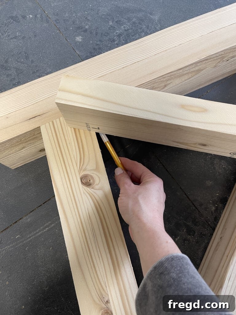 Marking and cutting the first X-bracing piece.