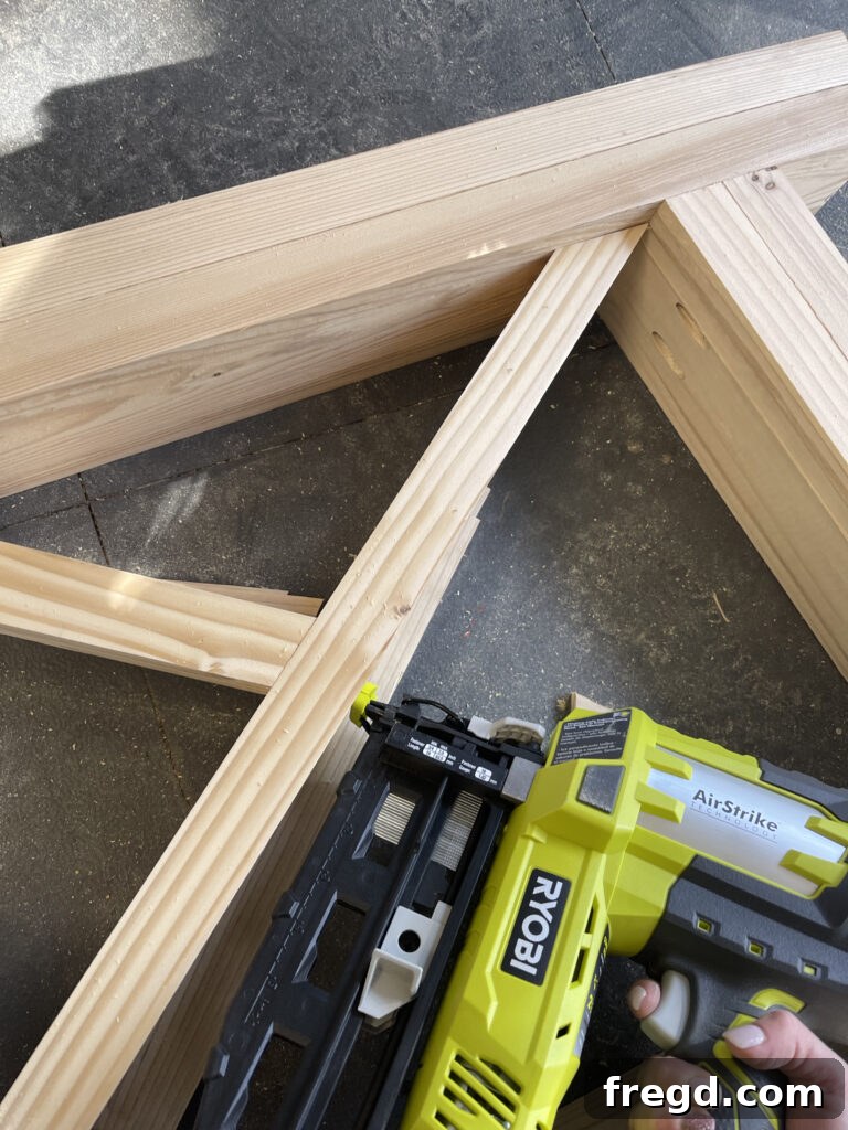 Attaching X-bracing with wood glue and finish nails.