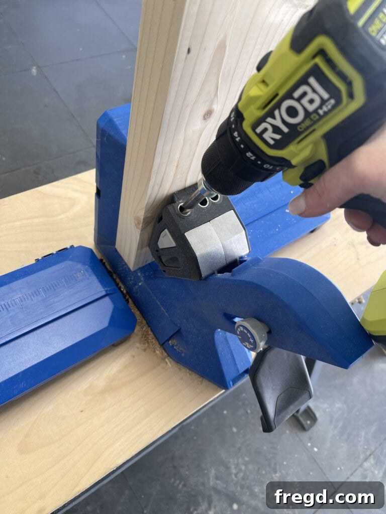 Drilling pocket holes into tabletop planks using a Kreg Jig.