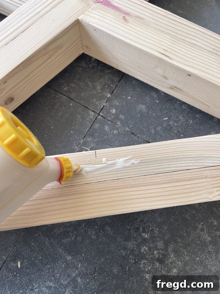 Attaching the top base runner to the X-base leg assemblies.