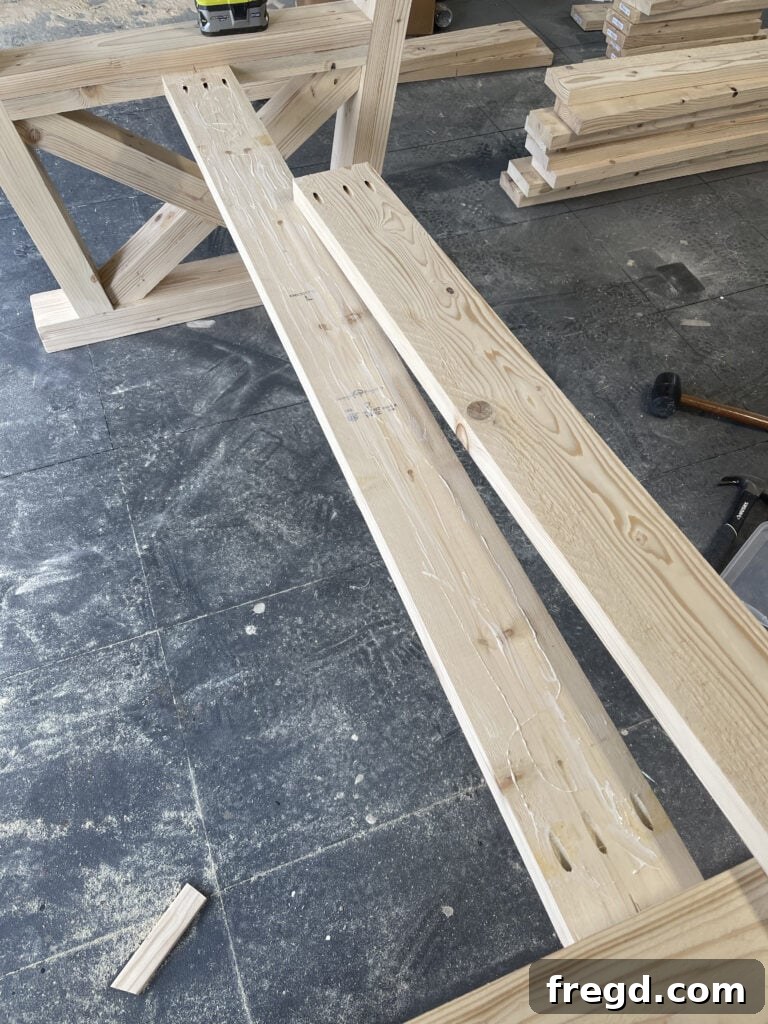 Securing the top runner to the leg assembly.