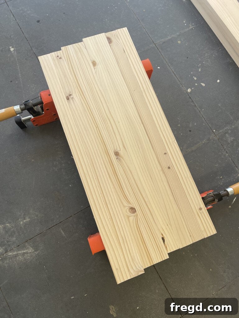 Applying wood glue to laminate leg boards.