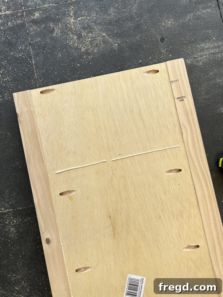 Plywood shelf with pocket holes along all edges.