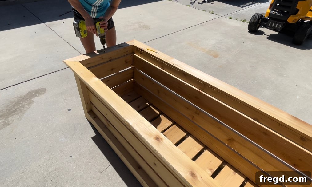 Attaching the top short angle trim pieces to the planter box