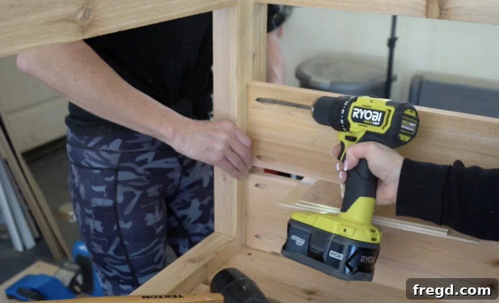 Attaching side slats to the inside of the planter legs