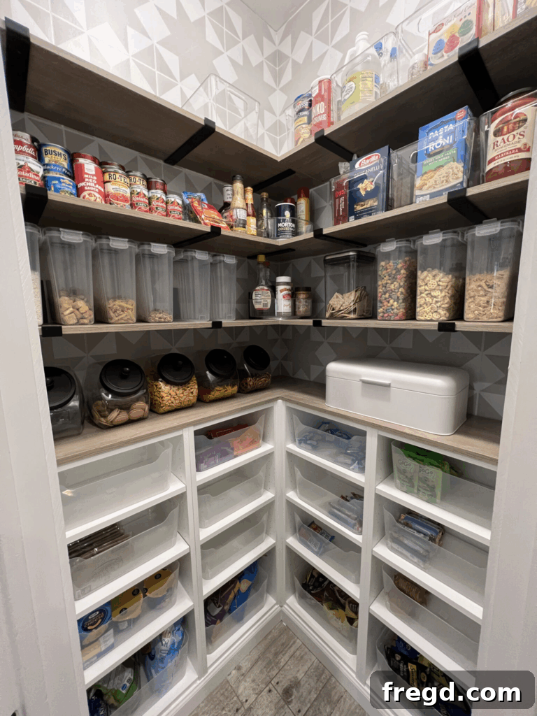 Beautifully organized corner pantry with white shelves, black accents, and clear storage bins. The image showcases a complete transformation from a cluttered to a highly functional and stylish space.