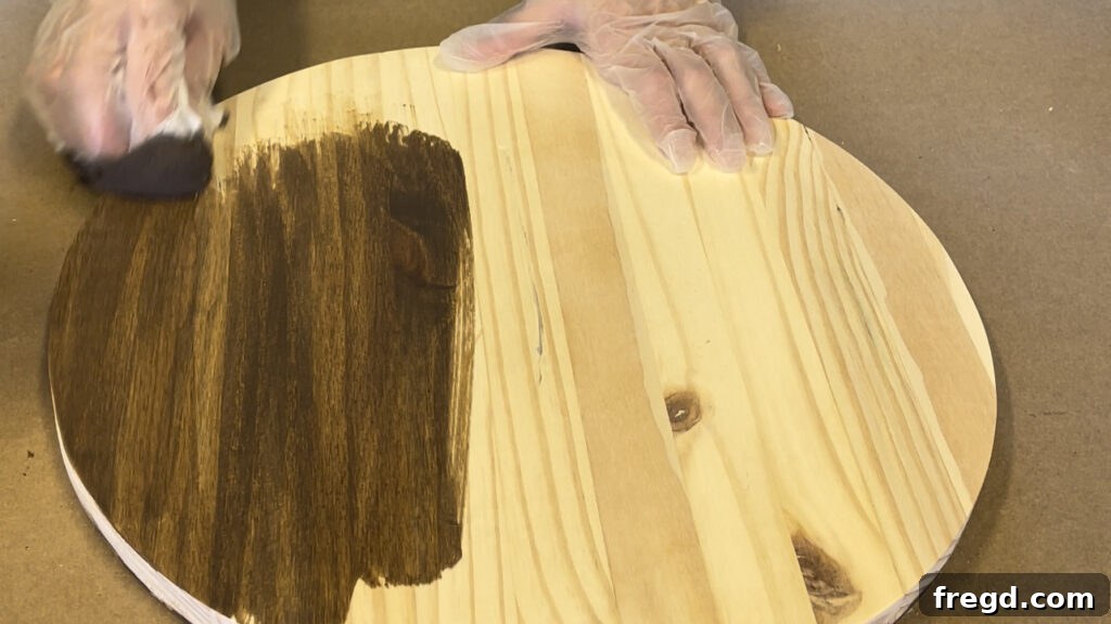 Applying stain and finish to a wood circle for a side table.