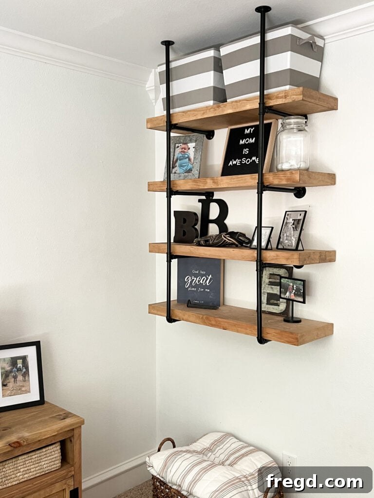 Installed DIY pipe shelves in Brooks' room