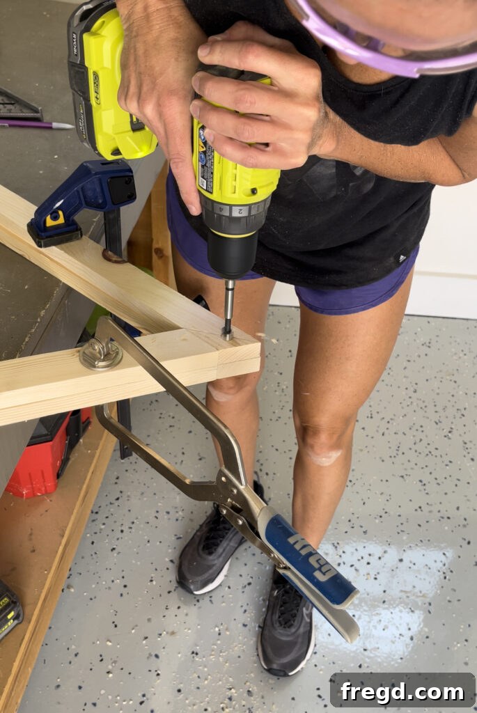 Stacked frames being drilled for dowel holes