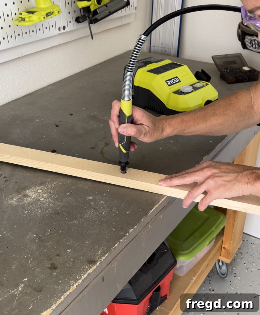 Sanding the edges of drilled dowel holes with a rotary tool