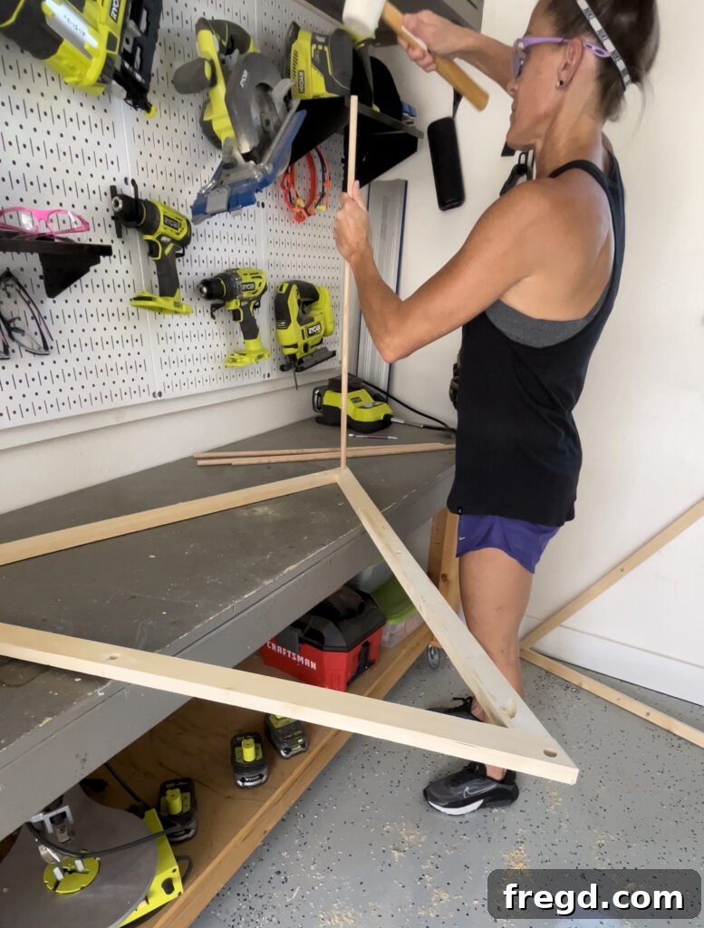 Sliding dowels into the holes of one frame for the doghouse bed