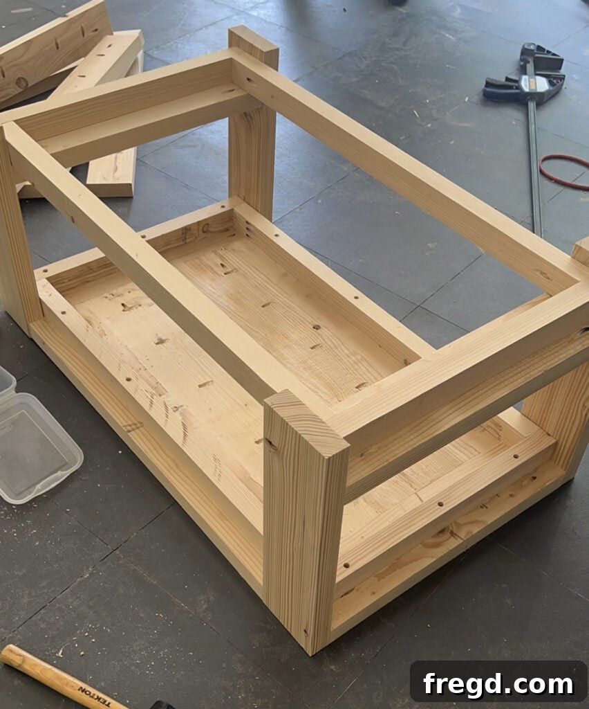 Craft Your Seven-Board Coffee Table 13 Attaching the coffee table tabletop to the main body using pocket hole screws from underneath for a clean finish.