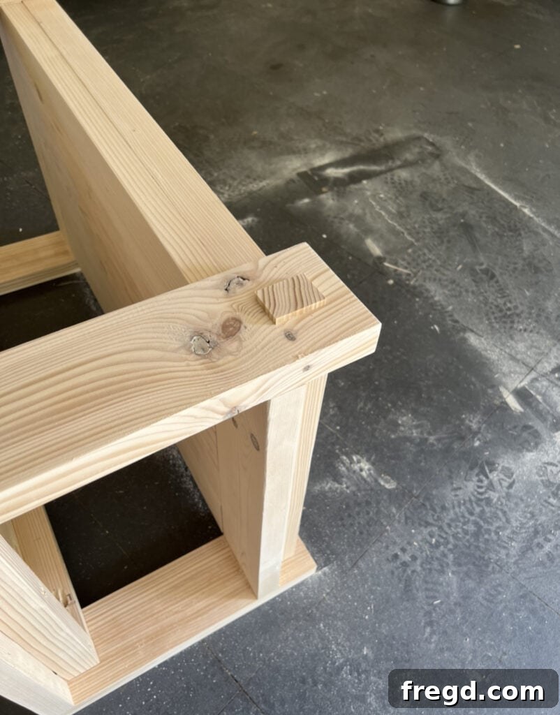 Craft Your Seven-Board Coffee Table 15 Attaching decorative trim pieces to the coffee table legs with wood glue and brad nails for a refined and finished look.