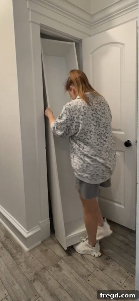 Securing the IKEA Billy bookcase to the wall studs in the cleaning closet