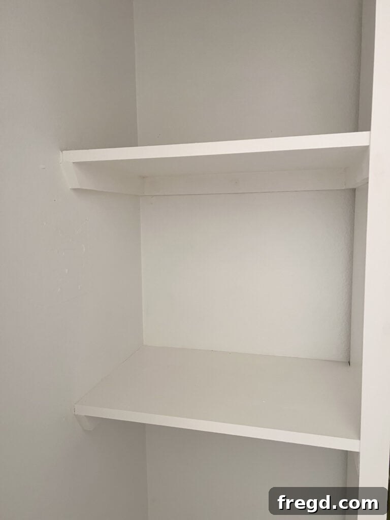 Custom wooden shelves added next to the Billy bookcase in the cleaning supply closet