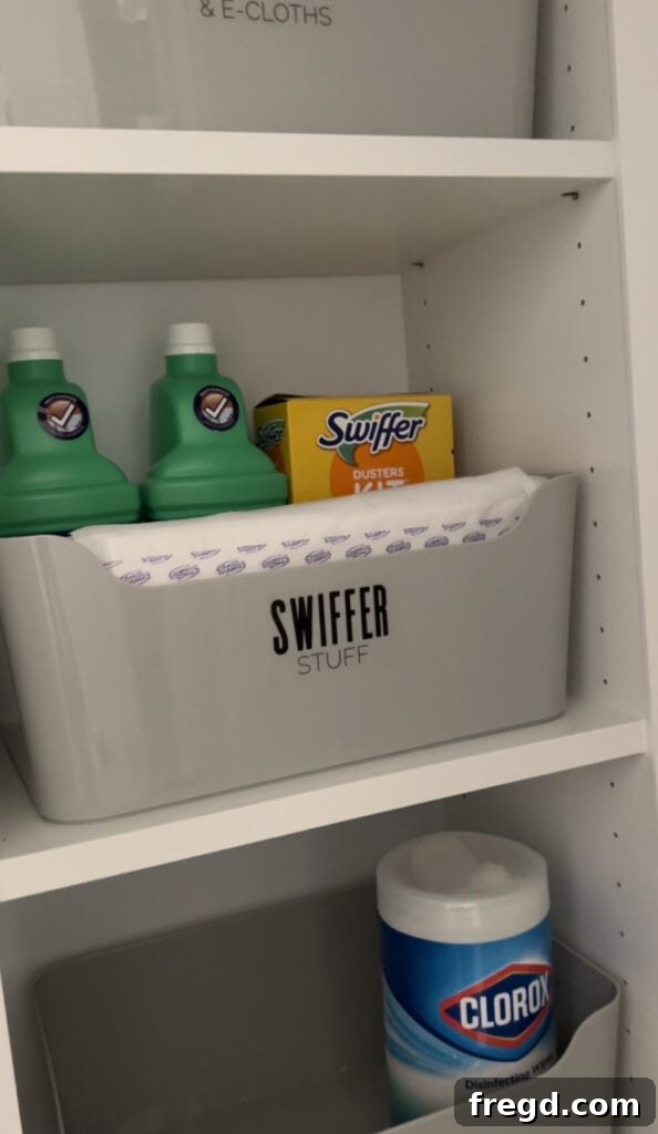 Organized cleaning supplies in grey storage baskets on closet shelves