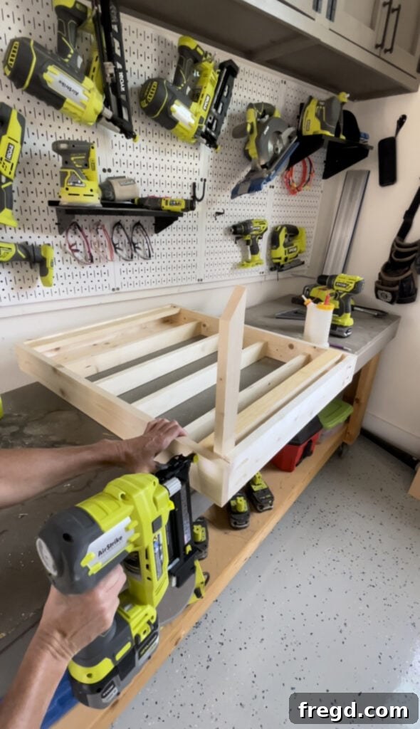 Elevate Your Bathroom with DIY Mirrored Storage 7 Shows the attachment of front cleats inside the cabinet frame using brad nails and a spacer.