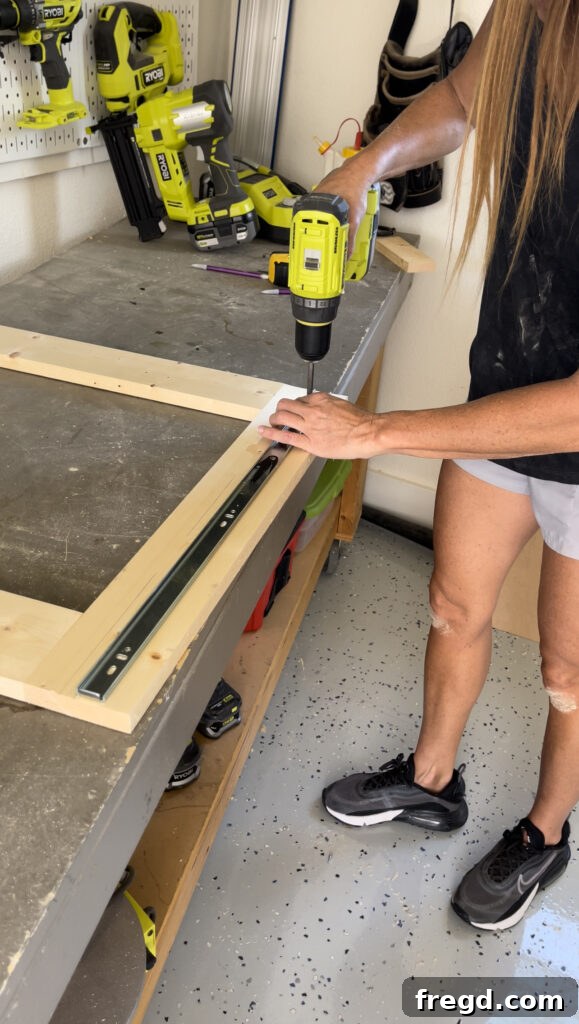Elevate Your Bathroom with DIY Mirrored Storage 9 Shows the attachment of the narrower, inner part of drawer slides to the back of the mirror frame.