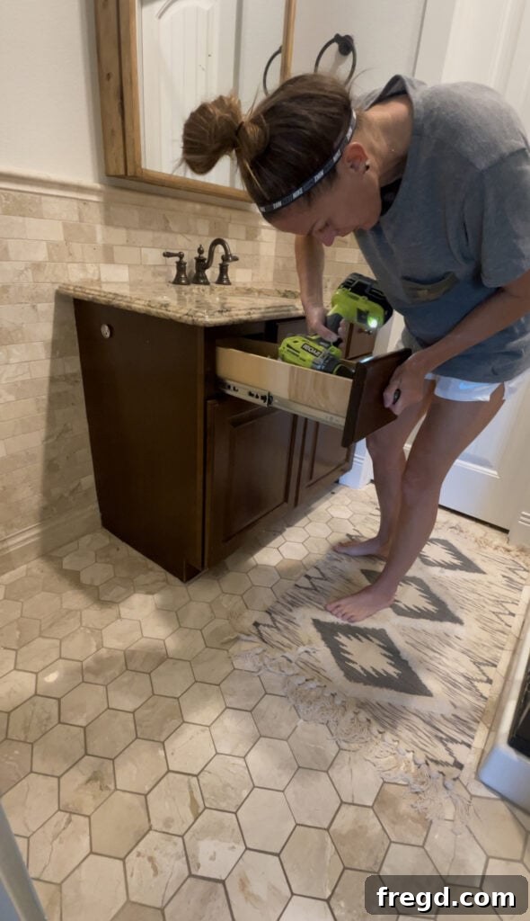 Removing old cabinet hardware from a bathroom vanity