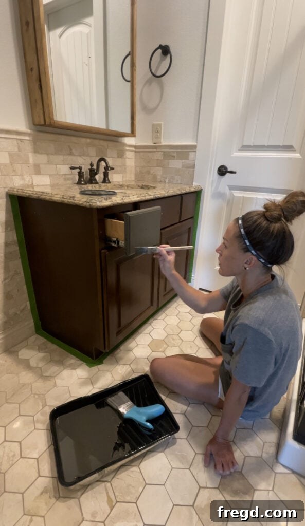 Painting the intricate details of the vanity frame