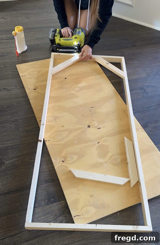 Corner frame pieces being attached to the main frame using brad nails.