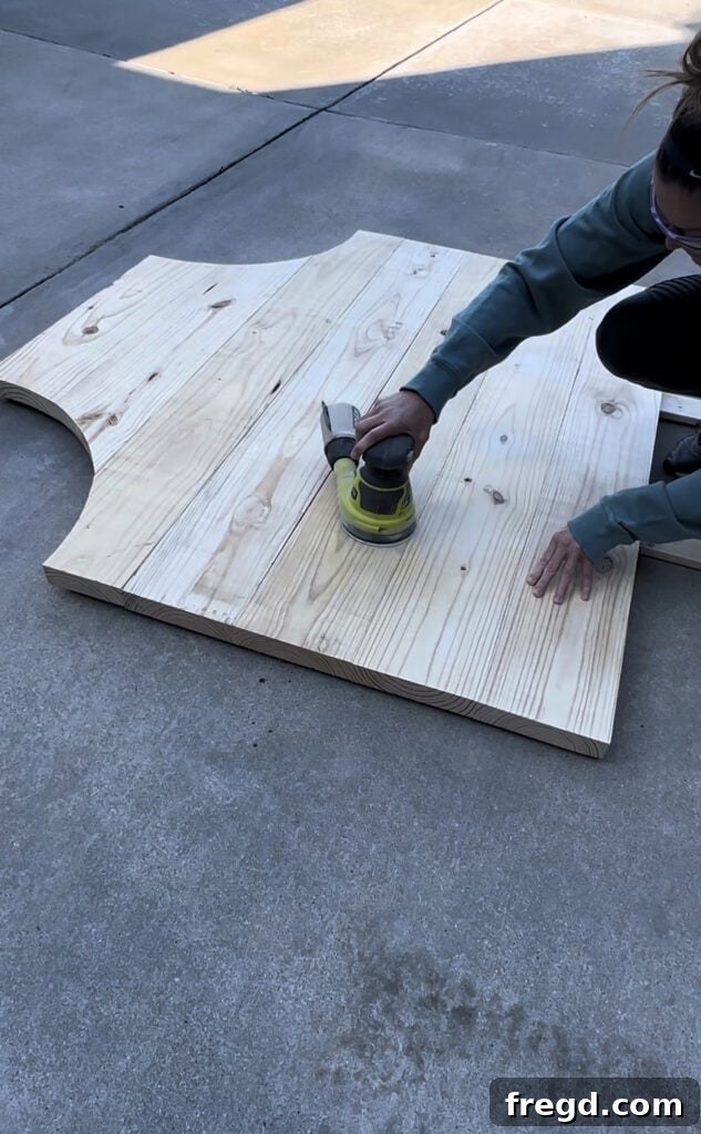Sanding the bed frame for a smooth finish