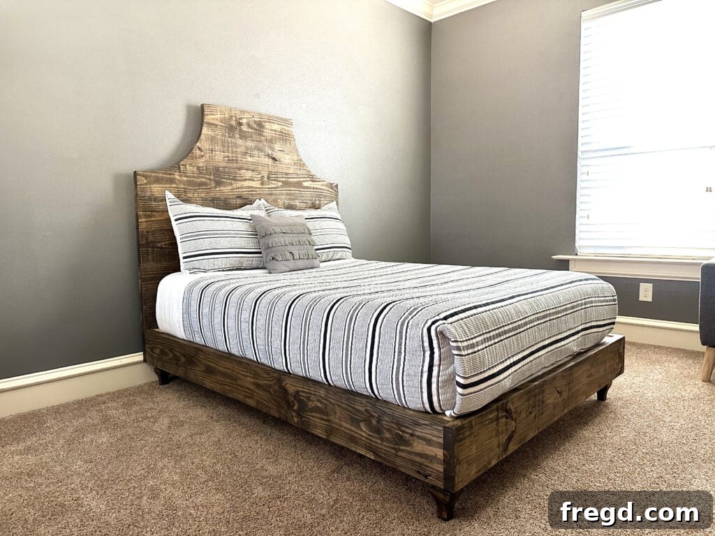 Finished DIY full size bed with fancy headboard in a guest room