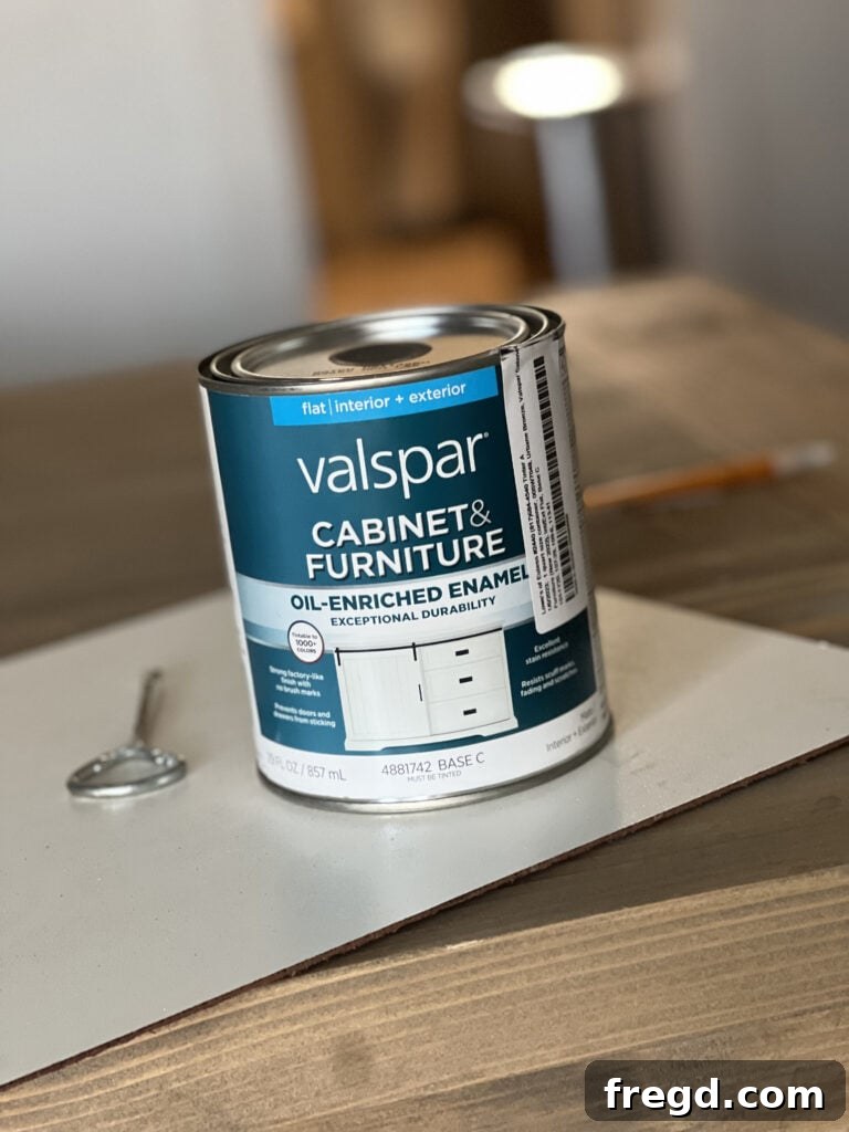 Transform Your Home with DIY Board and Batten Paneling 13 Applying Sherwin-Williams Urbane Bronze paint to the newly installed board and batten wall.