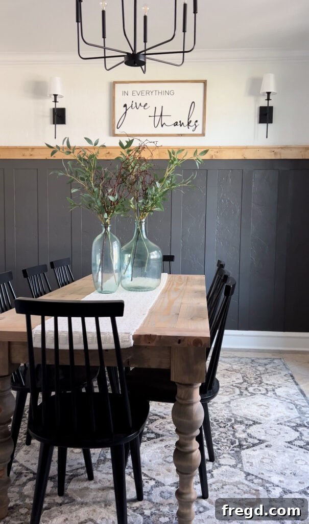 Transform Your Home with DIY Board and Batten Paneling 18 Detailed shot of the finished board and batten with stained top trim, highlighting the seamless blend and quality of the DIY work.