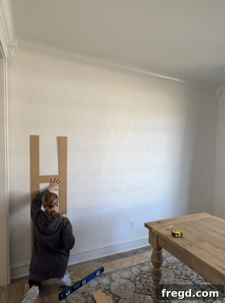 Transform Your Home with DIY Board and Batten Paneling 4 Using a long level to ensure the first vertical batten board is perfectly straight before securing it to the wall.